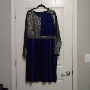 Navy blue velvet dress with black sheer  sleeves sparkles on front right side.